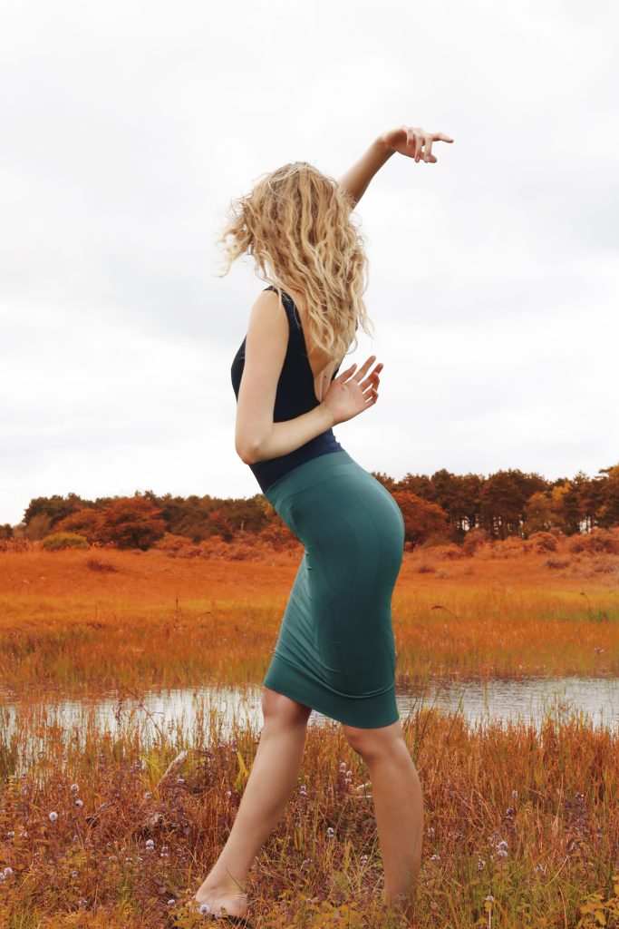 Woman in activewear dancing in nature
